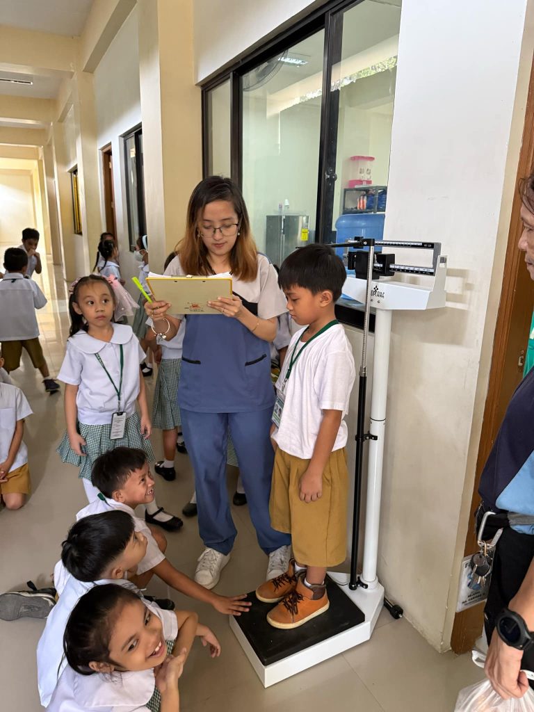 Nurse Joan Conducts SBFP Midyear Weighing and Feeding